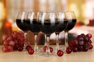 Red wine in glass on room background photo