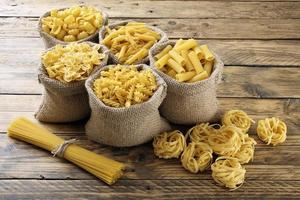 top view Various types of Italian pasta rustic background