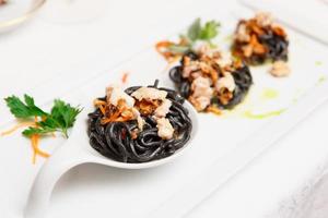 Black pasta with seafood, close-up photo