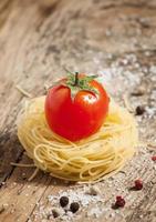 Fidellini dried pasta and fresh organic tomatoes photo