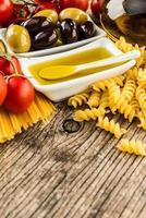 Italian food ingredients on wooden background photo
