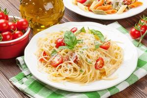 Spaghetti and penne pasta with tomatoes and basil photo