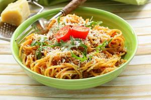 traditional pasta with tomato sauce spaghetti bolognese with parmesan photo