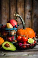 Fruits and vegetables on wooden background photo