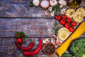 Pasta ingredients  on a wooden background photo