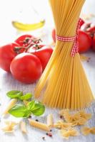 raw pasta olive oil tomatoes. italian cuisine photo