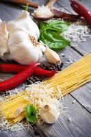Pasta, garlic, pepper, basil and parmigiano photo