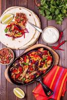 Pork fajitas with onions and colored pepper, served with tortill