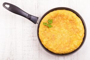 Delicious Spanish tortilla (omelette) in the frying pan