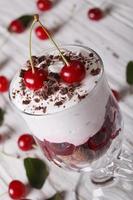 Black forest cherry dessert in a glass close-up. Vertical