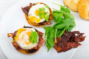 Eggs benedict with bacon and spinach