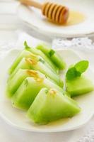 Appetizer of green watermelon with honey.