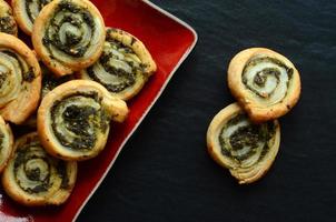 Puff pastry rolls with spinach and greek cheese filling photo