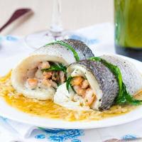 Fish rolls of dorado fillet stuffed shrimp, spinach with onion