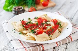 Delicious ravioli with tomato sauce and dill photo