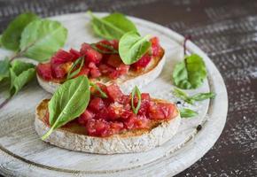 bruschetta with tomatoes and fresh spinach photo