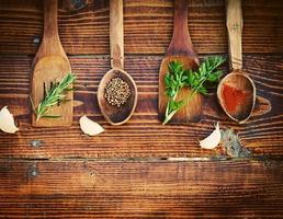 Spices and herbs on wooden table. Top view photo