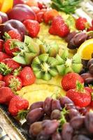 Healthy fruit breakfast with strawberry grape pineapple and kiwi photo