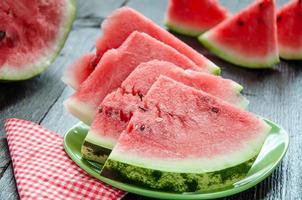 Ripe watermelons on table on the wooden background photo