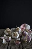 Russian Red Garlic bulbs and cloves on rustic wooden surface