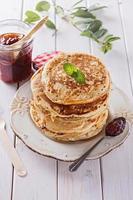Healthy oat pancakes over white wooden background photo
