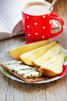 Breakfast: blue cheese, wholegrain crisp, pear and coffee with milk photo
