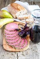 Slices of italian salami with pears and wine photo
