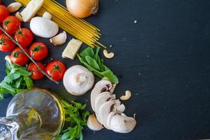 Italian background - pasta, tomato, onion, mushroom, olive oil, arugula
