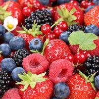 Berry fruits in summer with strawberries, blueberries and raspberries photo