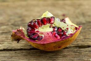 Pomegranate isolated on wooden background