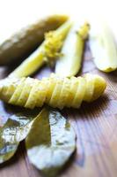 Pickled cucumbers with dill seeds and bay leaves photo