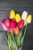 tulip bouquet on dark wooden background