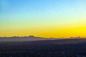 golden sunset in Tuscon, Arizona with mountain range photo