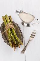 Fresh asparagus on a white wooden background