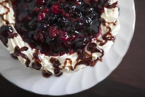 Cake with fresh berries and cream, closeup.