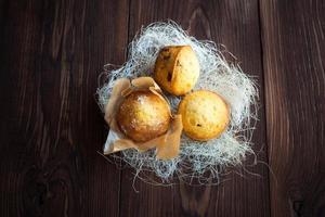 Homemade muffins with decoration on wood table photo