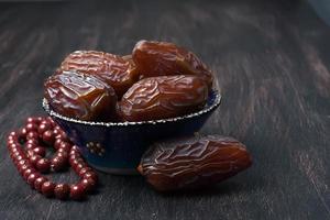 Dates fruit and rosary still life photo