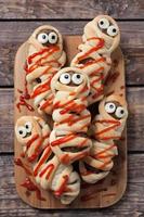 Sausage meatball mummies wrapped in dough and baked. Scary halloween