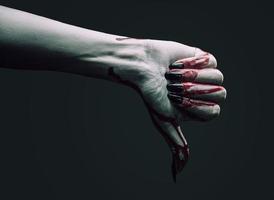 Vampire hand shows thumb down gesture photo