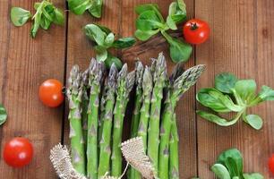 organic asparagus on wooden table photo