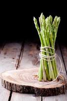 Fresh asparagus on a wooden background photo