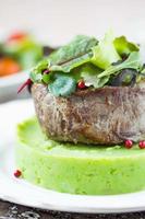 Grilled beef steak, green mashed potatoes with peas, herbs