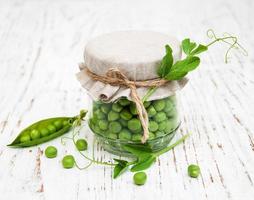 Jar with fresh peas photo