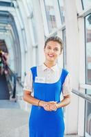 Beautiful young flight attendant in the airport. photo