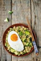 stir fried millet with broccoli, green beans and fried egg photo