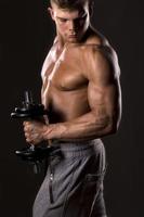 muscular bodybuilder lifting weight photo