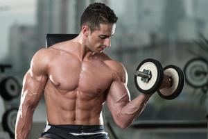 Young Man Exercise With Dumbbells photo