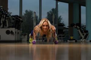 Healthy Middle Age Woman Doing Push Up Exercise photo