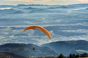 Paraglider is flying in the valley photo