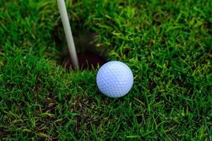 golf ball hole on a field photo